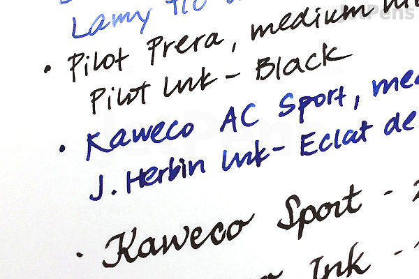 Close-up photo of handwritten text on white Tomoe River 52 gsm Kanso Notebook paper, showing various pen and ink names written in black ink with smooth, clear strokes.