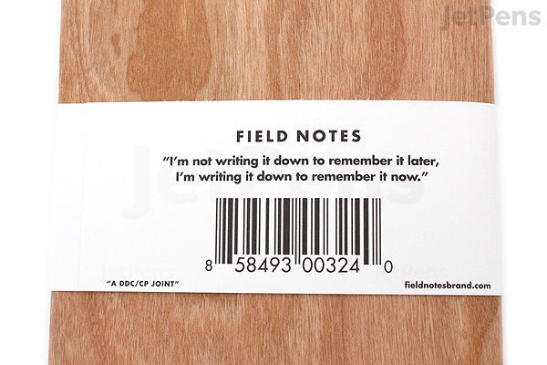 Three Field Notes memo books with a cherry wood grain cover, each measuring 3.5 by 5.5 inches, featuring 48 pages of graph paper, stacked and wrapped with a white paper band.