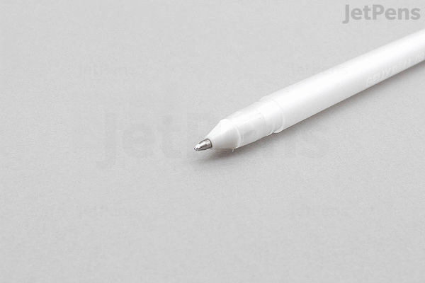 A close-up image of a Sakura Gelly Roll Classic gel pen in white color, showing the pen tip and part of the barrel on a light gray background. The pen has a medium 0.8 mm tip.