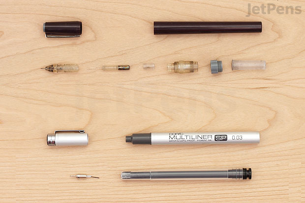 A metal-tipped technical drawing pen compared with a plastic-tipped pen.