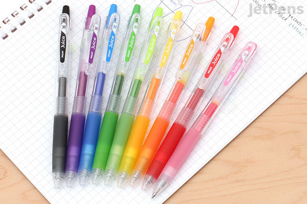 Set of ten Pilot Juice Gel Pens with 0.38 mm tips, arranged on a wooden surface and white paper. Pens have translucent barrels and caps with colored grips and clips in various colors.