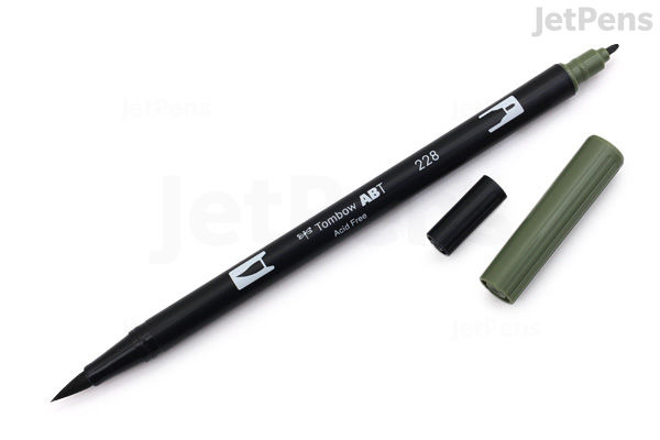 A Tombow Dual Brush Pen in Gray Green (228) with its cap removed and placed beside the pen, showing the fine tip on one end. The pen body is black with white text and a colored cap matching the ink color.