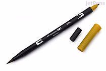 A Tombow Dual Brush Pen in Green Ochre (076) with its black fine tip exposed and the yellowish-green cap removed and placed beside it. The pen body is black with white text and a color indicator on the opposite end.