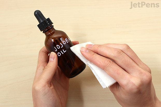 Paint pen being removed from a bottle