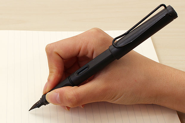 Hold the fountain pen using your preferred grip style. Make sure the nib is facing up and angled at about 45 degrees to the paper.