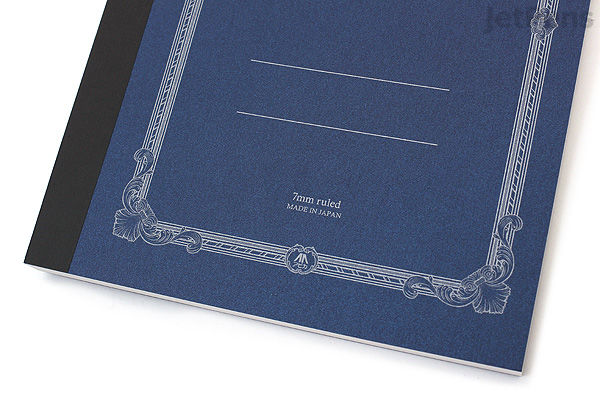 Close-up of two Apica Premium C.D. Notebooks in A5 size, featuring dark blue and black covers with decorative borders and 7 mm ruled pages inside. The notebooks have a classic, elegant design.