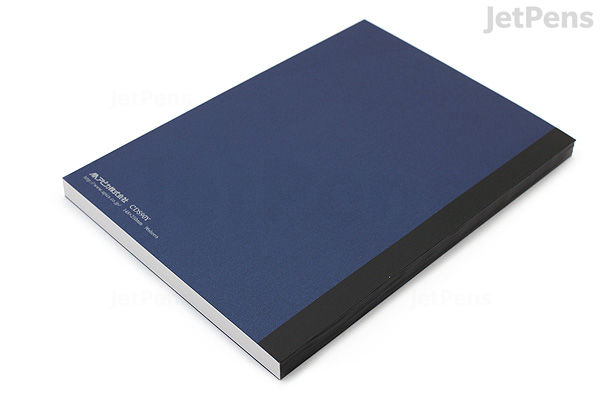 A closed Apica Premium C.D. Notebook in A5 size with a dark blue cover and black spine, featuring 7 mm ruled lines.