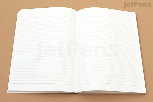 Open Apica Premium C.D. Notebook in A5 size showing two pages with 7 mm ruled lines on cream-colored paper.