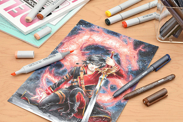 A detailed anime-style drawing featuring a character surrounded by fiery effects, created with Copic Multiliner pens and markers. Several art supplies, including a 0.03 mm black Copic Multiliner pen, are visible on a wooden surface.
