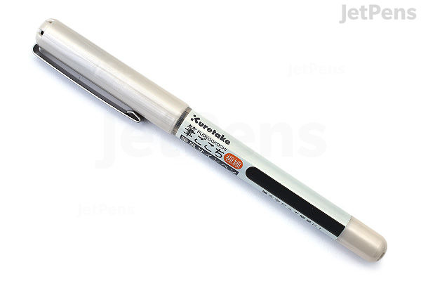 A Kuretake Fudegokochi Brush Pen with an extra fine black tip, featuring a silver body and cap, lying diagonally on a white background.