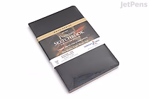 A Stillman & Birn Nova Sketchbook in softcover with black cover, measuring 5.5 by 8.5 inches, wrapped in a branded paper band.