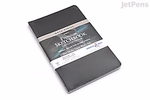 A grey Stillman & Birn Nova Sketchbook with a softcover, measuring 5.5 by 8.5 inches, shown closed with a branded paper band around it.