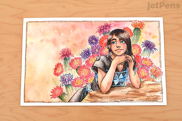 A watercolor painting of a girl with long dark hair resting her chin on her hands, surrounded by colorful flowers in shades of pink, purple, and red, set against a warm, peach-toned background. The artwork is placed on a wooden surface.