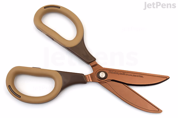 A pair of Nakabayashi Sakutto Cut Hikigiri scissors with titanium-coated blades in a mocha color. The scissors have ergonomic handles with a soft brown grip and a slightly curved blade design.