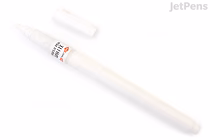 A white Kuretake ZIG Cartoonist Brush Pen with its cap removed, showing the small brush tip, placed on a white background.