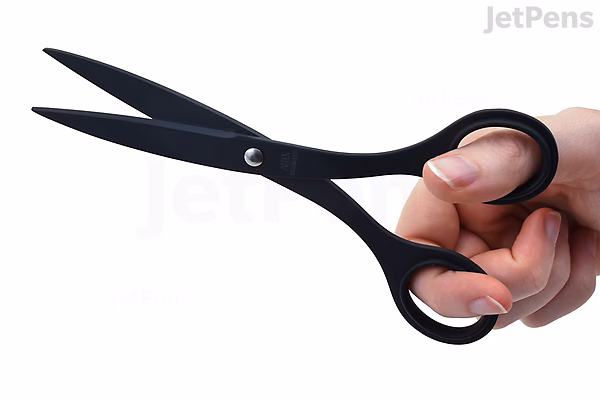 A hand holding a pair of black office scissors with a fluorine-coated finish, labeled Allex S-165F. The scissors have a sleek, matte appearance and ergonomic handles.