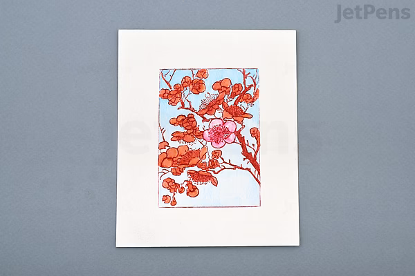 A detailed illustration of a branch with peach-colored flowers and buds, created using Tombow Dual Brush Pen in peach (020) on white paper, set against a gray background.