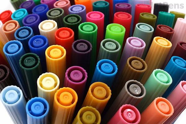 A close-up view of the caps of Tombow Dual Brush Pens arranged closely together, showcasing a variety of vibrant colors from the 20-color Floral Palette set.