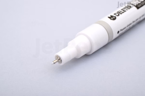 Close-up image of a Deleter Neopiko Line White Drawing Pen with a 0.5 mm tip, shown on a light gray surface. The pen is white with black text and has a fine metal tip for precise drawing.