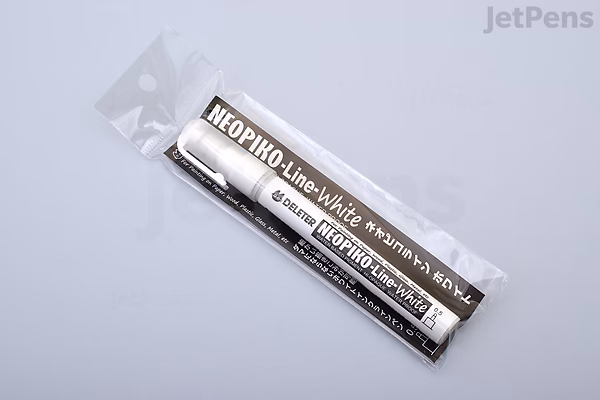 A Deleter Neopiko Line White Drawing Pen, 0.5 mm tip, packaged in clear plastic on a light gray background. The pen is black and white with Japanese and English text on the label.