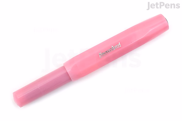 A Kaweco Frosted Sport fountain pen in a soft pink shade called Blush Pitaya, shown capped and lying horizontally on a white background. The pen has a broad nib and a frosted, semi-transparent finish.