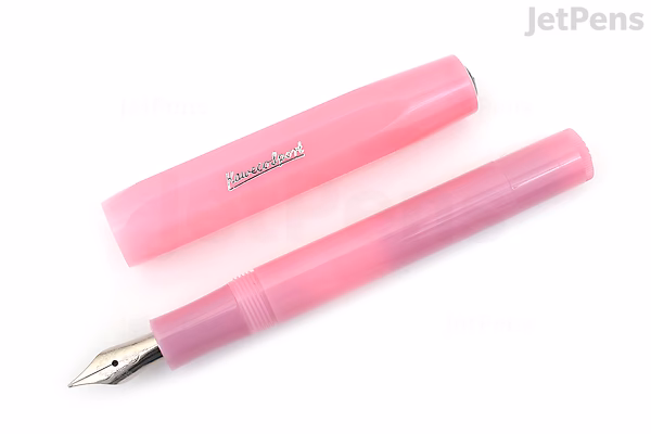 A Kaweco Frosted Sport fountain pen in blush pink color with a fine nib, shown uncapped next to its matching cap. The pen has a translucent, frosted finish.