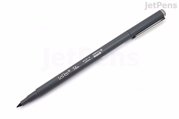 A Marvy Le Pen Flex Brush Pen in dark grey with a fine, flexible brush tip and a matching dark grey cap. The pen body has white text indicating the brand and pen type.