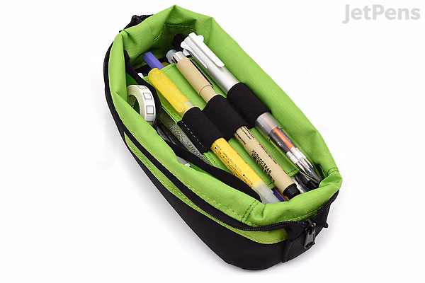 A black and bright green pen case shaped like a small boat, containing several pens and pencils secured in elastic loops inside.