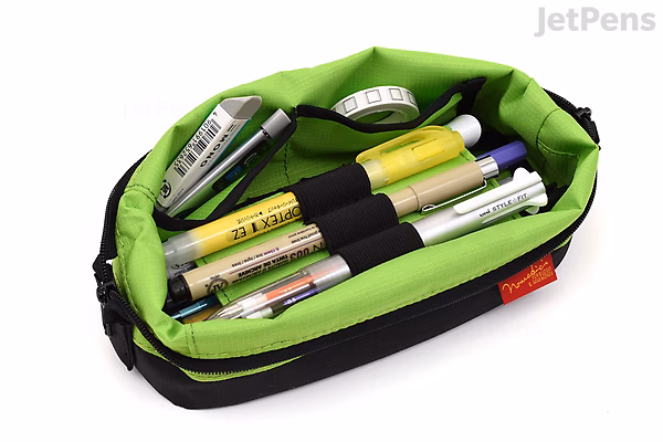 Black boat-shaped pen case with a bright green interior, containing several pens and markers secured by elastic loops.