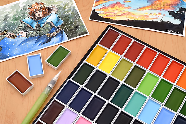 A set of Kuretake Gansai Tambi watercolor paints with multiple vibrant color pans arranged in rows, accompanied by a paintbrush and two watercolor paintings featuring a fantasy character and a sunset landscape.