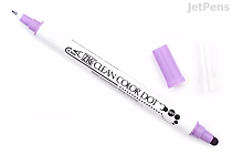 A double-sided marker labeled "ZIG Clean Color Dot" with a purple cap on one end and a clear cap on the other. The marker body is white with black text and dot designs. The purple cap is removed and placed beside the marker, revealing a round purple tip.