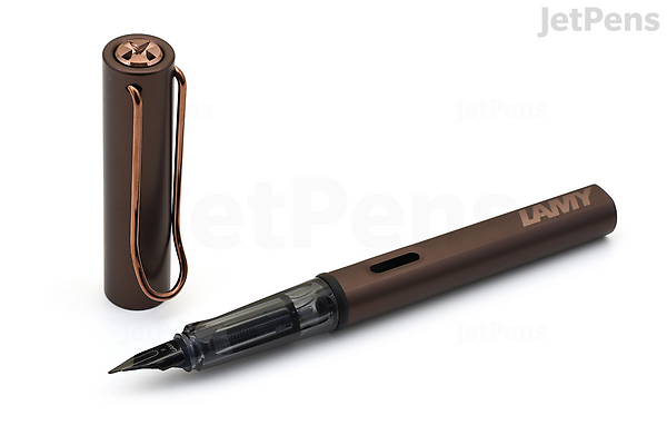 A LAMY Lx Marron fountain pen with an extra fine nib, shown uncapped with the cap placed beside it. The pen has a sleek, metallic brown body and a black nib.