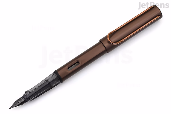A sleek LAMY Lx Marron fountain pen with a medium nib, featuring a smooth brown metallic finish and a black grip section. The pen is shown uncapped, with the cap placed beside it.