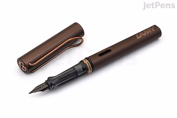 A LAMY Lx Marron fountain pen with an extra fine nib, shown uncapped. The pen has a sleek, dark brown metallic body with a matching clip, and the nib is black with fine detailing. The cap is placed beside the pen on a white background.