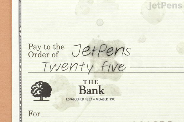 A check with water spots on it, showing that the ink has run.
