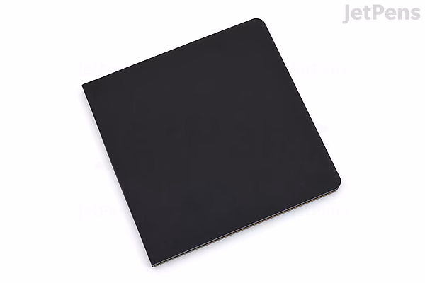 A closed, black, square-shaped softcover sketchbook measuring 7.5 by 7.5 inches, identified as a Stillman & Birn Nova Sketchbook from the Mixed Trio series.