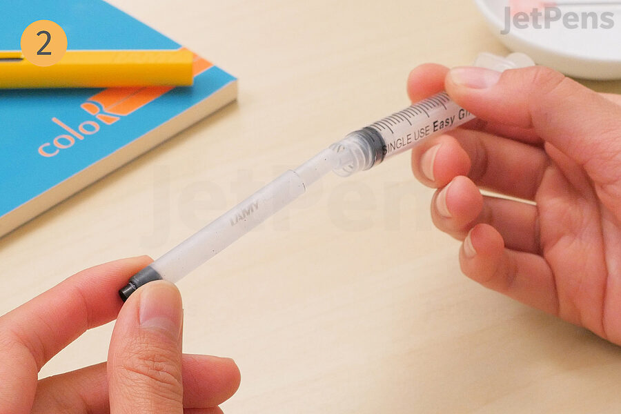 2. Insert the open end into the syringe.