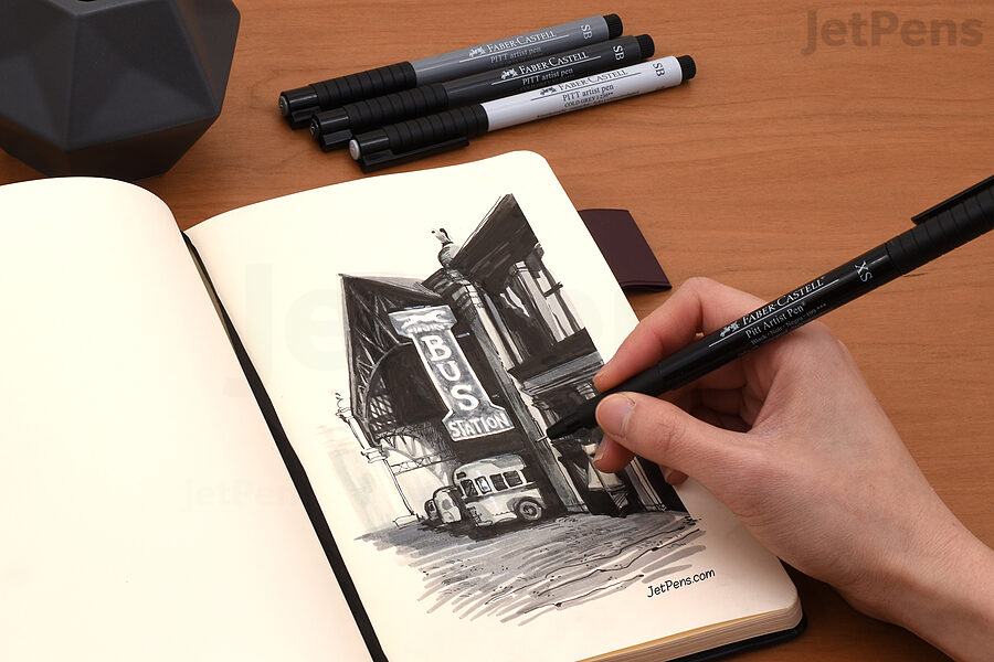 A sketch of a bus station made in a blank Rhodia webnotebook with Faber-Castell PITT Artist Soft Brush Pens and standard Faber-Castell PITT Artist Pens.
