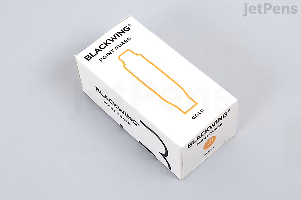 A white rectangular box labeled "Blackwing Point Guard Pencil Cap" with an illustration of a gold pencil cap on the front. The box is placed on a light gray surface.
