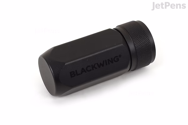 Blackwing One-Step Long Point Pencil Sharpener in black, shown at an angle on a white background.