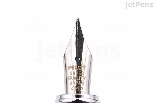 Close-up of a Pilot Prera fountain pen nib in medium size, featuring a silver-colored metal tip with engraved text and a black ink slit.