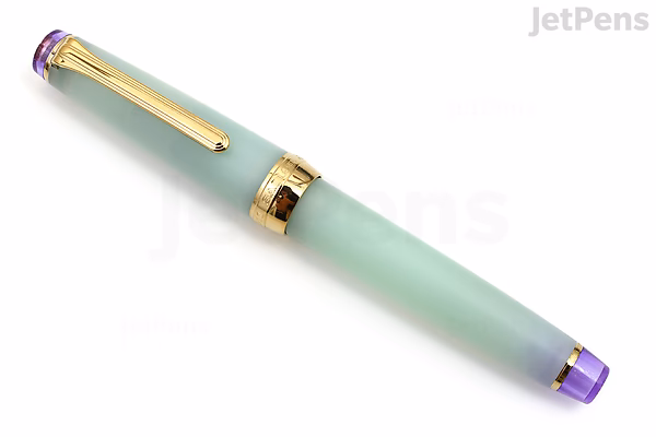 Image of a Sailor Pro Gear Slim Shikiori fountain pen in the Haru-same (Spring Rain) design. The pen has a smooth, matte light green barrel and cap, accented with gold trim and a purple finial on the cap and end. The nib is 21k gold, medium fine.