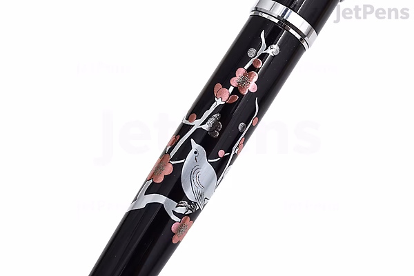 A black Platinum Procyon Maki-e fountain pen featuring a fine nib. The pen is decorated with an intricate design of a brush warbler bird perched on a plum tree branch with pink blossoms. This is a limited edition model.