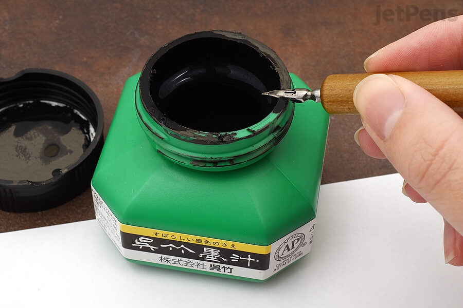 Get rid of excess ink by tapping or dragging the nib against the ink bottle.