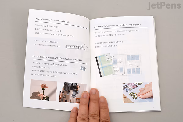 Open booklet showing instructions and illustrations for using the Himekuri Sticky Note Calendar 2022, held by a hand on a white surface. Text and images explain calendar setup and usage tips.