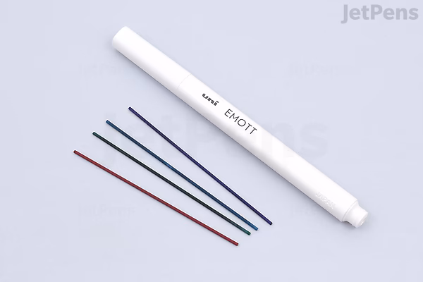 A white Uni EMOTT Color Mechanical Pencil with a 0.9 mm tip, shown alongside four colored ink lines in black, blue, red, and green. The pencil is labeled "EMOTT" and is part of a 4-color set called No. 1 Refresh.