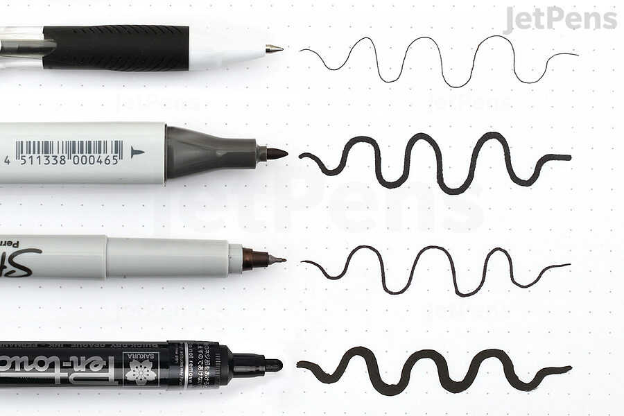 A selection of oil-based and alcohol-based  pens, caps off, pointing at wavy lines drawn by these pens.