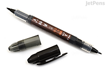 Double-sided black brush pen with fine and medium tips, labeled Pilot Shunpitsu Pocket Brush Pen, shown with both caps removed and placed nearby.