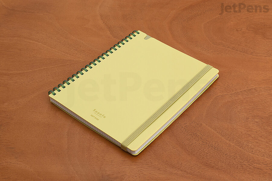 The soft plastic rings of the Kokuyo Sooofa Notebook keep your wrist comfortable as you reach across it to write.