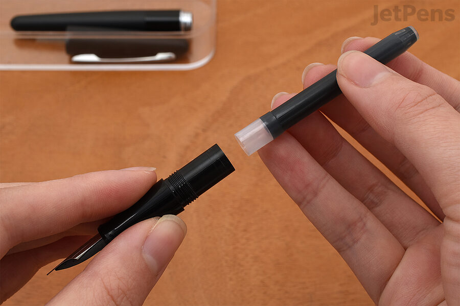 1. Push the wide end of the cartridge into the pen's grip section.